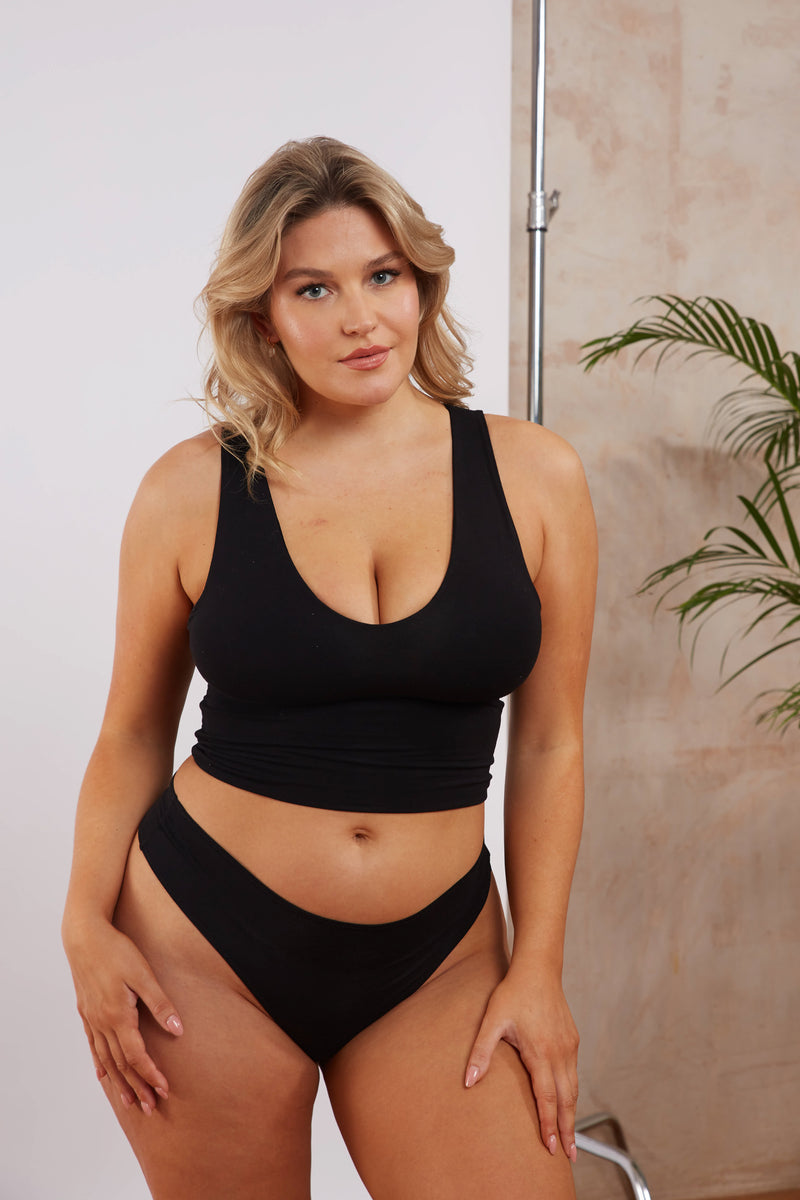 Model in black bamboo double layer tank top with hidden support