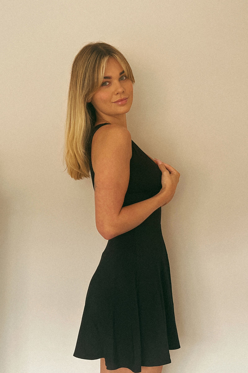 Women in mini dress circle skirt, wrap front top, black colour hidden bust support