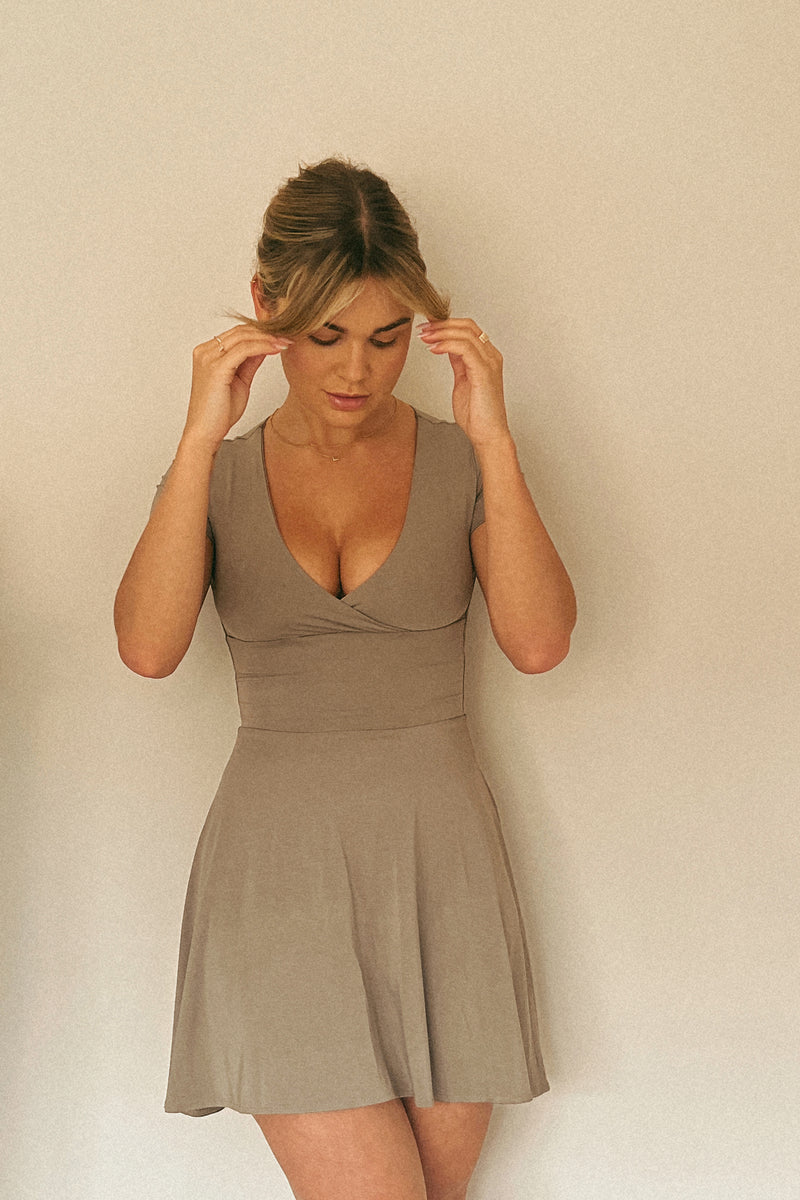 Women in mini dress circle skirt, wrap front top, khaki colour hidden bust support